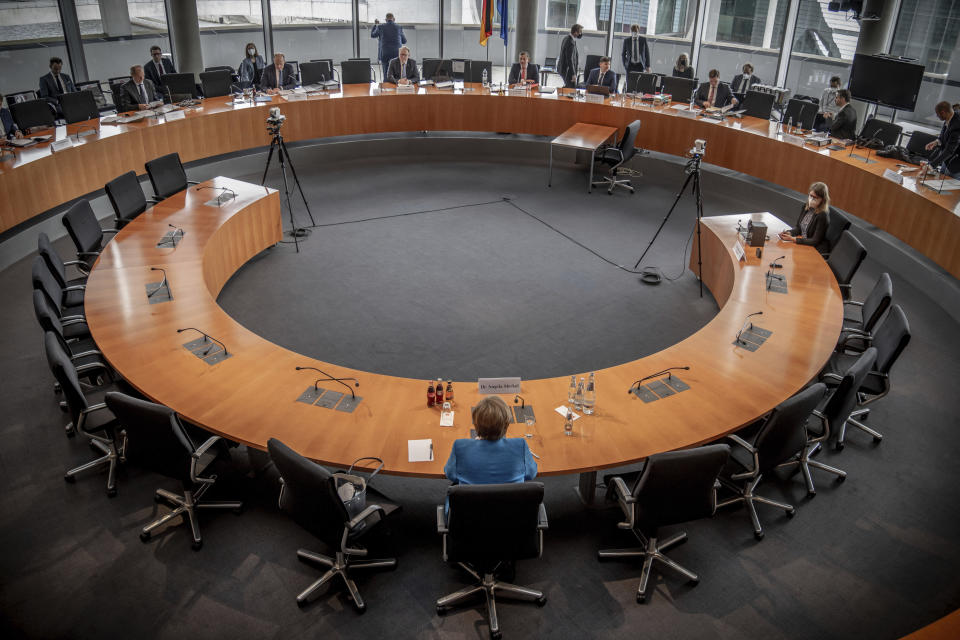 German Chancellor Angela Merkel arrives for the Wirecard investigation committee in Berlin, Germany, Friday, April 23, 2021. She has been summoned as a witness because she spoke up for Wirecard during a trip to China in September 2019. The 3rd Bundestag Investigative Committee is to investigate the conduct of the German government and the authorities under it in connection with the events surrounding the now insolvent financial services provider Wirecard. (Michael Kappeler/AP via Pool)