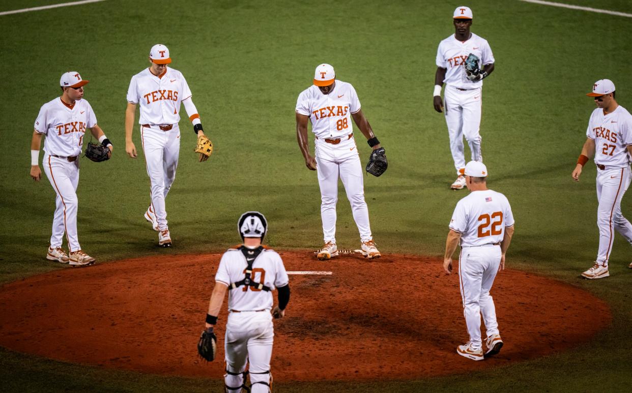 Texas Longhorns, including Head Coach David Pierce (22) gather around pitcher Andre Duplantier II (88) during a pause in the fourth inning of the LonghornsÕ game against the UTRGV Vaqueros at UFCU Disch-Falk Field, Tuesday, April 16, 2024.