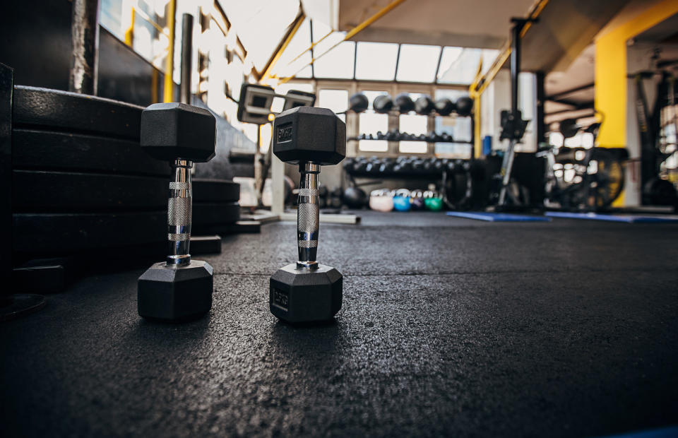 Dumbbells standing up on a gym floor