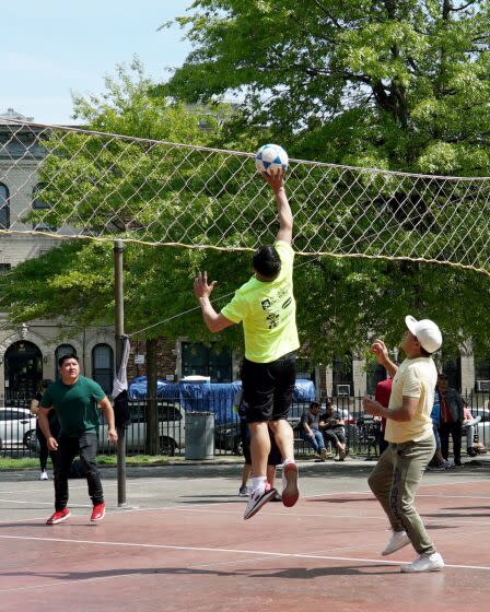 Brooklyn, New York - May 16: An ecuavoley player aims the ball over the net during the inner-borough championship at Morocho Volleyball League in Maria Hernandez Park.