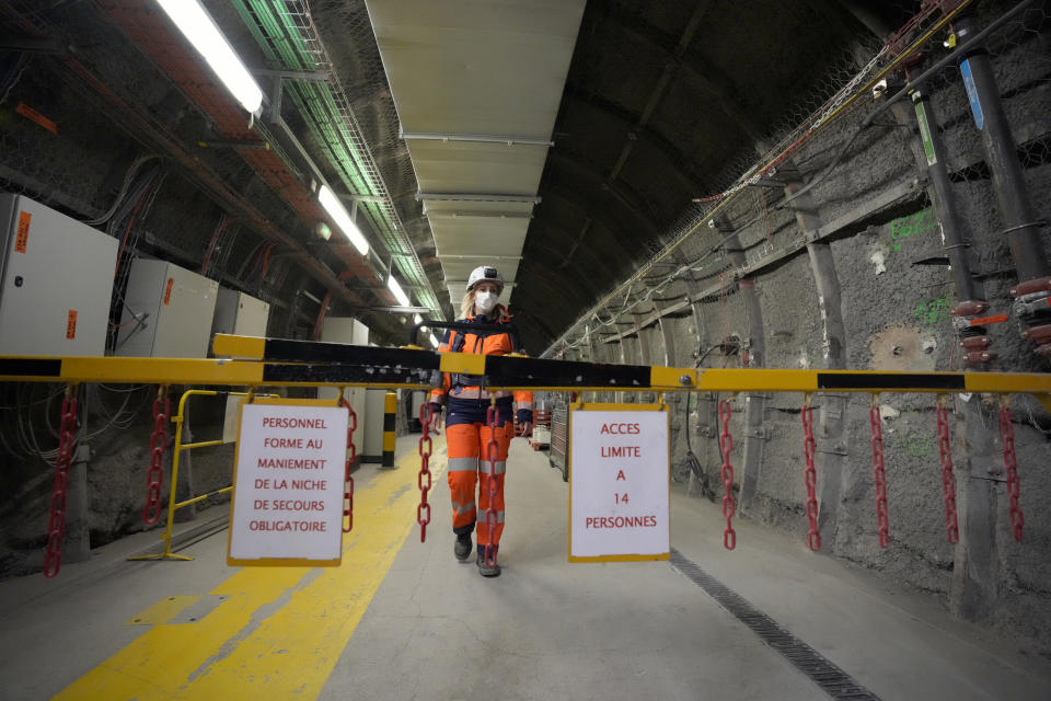 Audrey Guillemenet, geologist and spokesperson, walks in a tunnel for radioactive waste next to the emergency safety room in an underground laboratory run by French radioactive waste management agency Andra, in Bure, eastern France, Thursday, Oct. 28, 2021. Nuclear power is a central sticking point as negotiators plot out the world’s future energy strategy at the climate talks in Glasgow, Scotland. (AP Photo/Francois Mori)