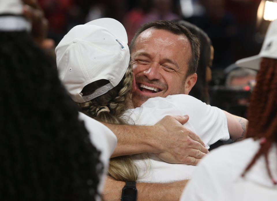 Louisville’s Jeff Walz hugs Emily Engstler as they celebrate winning the Elite Eight against Michigan.March 28, 2022