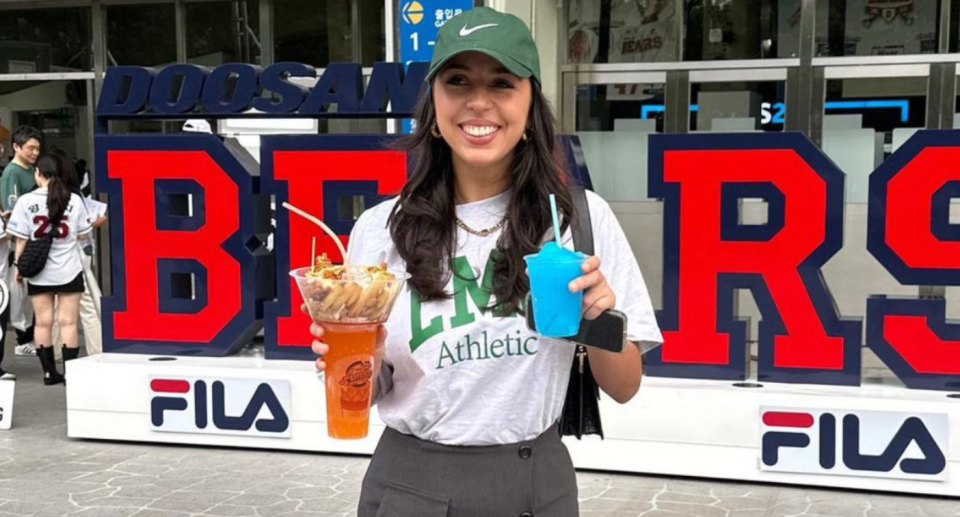 Demi holding drinks and food