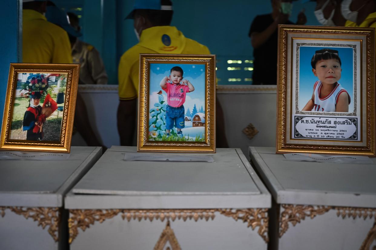 Portraits of victims sit atop coffins at Wat Si Uthai temple on Oct. 7, 2022 in Uthai Sawan subdistrict, Nong Bua Lamphu, Thailand. 