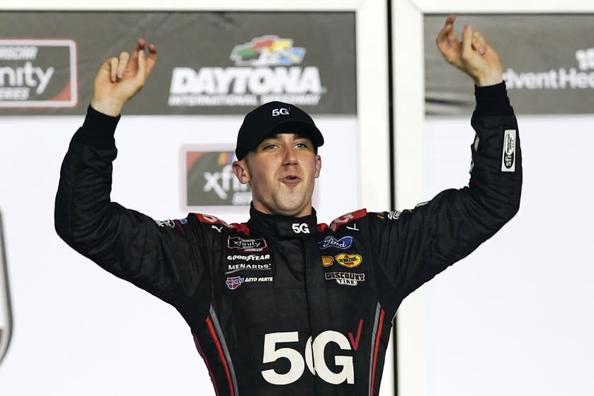 Austin Cindric celebrates in Victory Lane after winning the NASCAR Xfinity Series auto race at Daytona International Speedway, Saturday, Feb. 13, 2021, in Daytona Beach, Fla. (AP Photo/John Raoux)