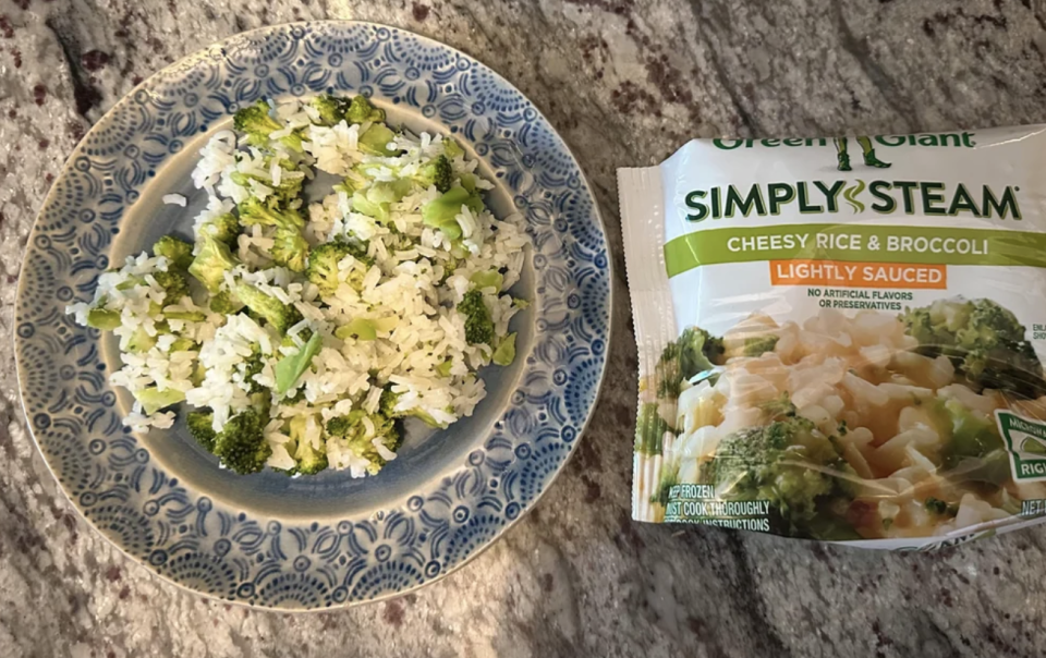 Prepared rice and broccoli dish on a plate next to its packaging, Green Giant Simply Steam Cheesy Rice & Broccoli