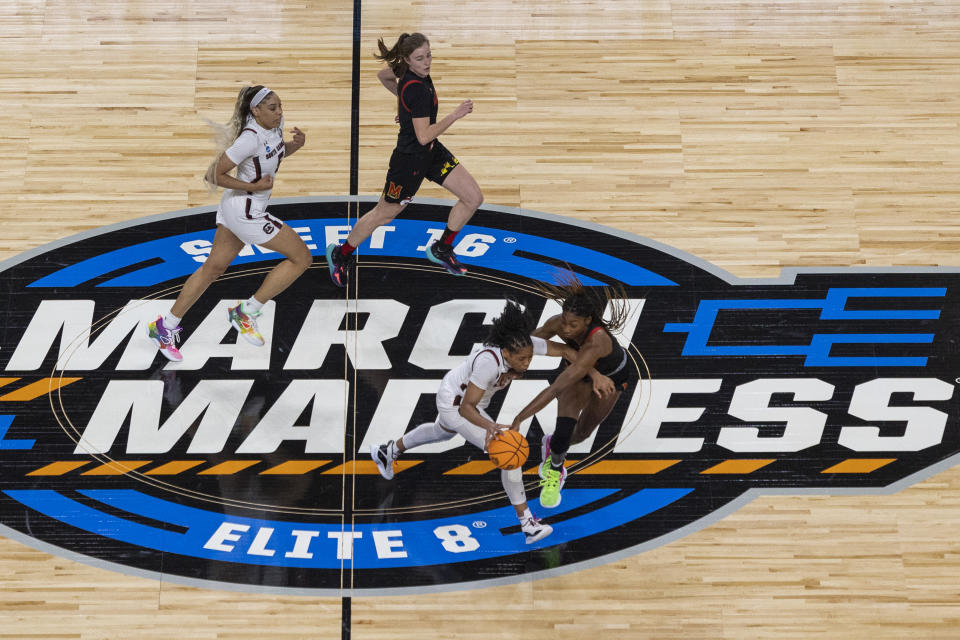 South Carolina's Zia Cooke dribbles the ball against Maryland's Diamond Miller, at bottom right, in the first half of an Elite 8 college basketball game of the NCAA Tournament in Greenville, S.C., Monday, March 27, 2023. (AP Photo/Mic Smith)