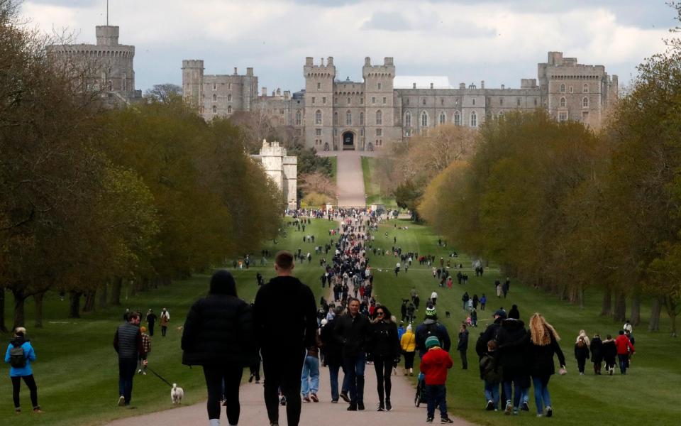 People walk on the long walk towards Windsor Castle, Windsor, England, Sunday, April 11, 2021, after the announcement of the death of Britain's Prince Philip on Friday. - Frank Augstein 