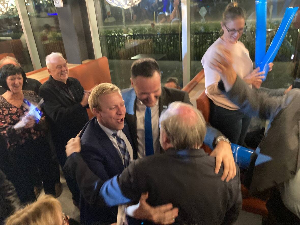 Coalition Avenir Québec candidates Mathieu Lévesque, left, Mathieu Lacombe, centre, and Robert Bussière, right, celebrate their respective victories in the Outaouais ridings of Chapleau, Papineau and Gatineau during Monday night's Quebec election.  (Rémi Authier/Radio Canada - image credit)