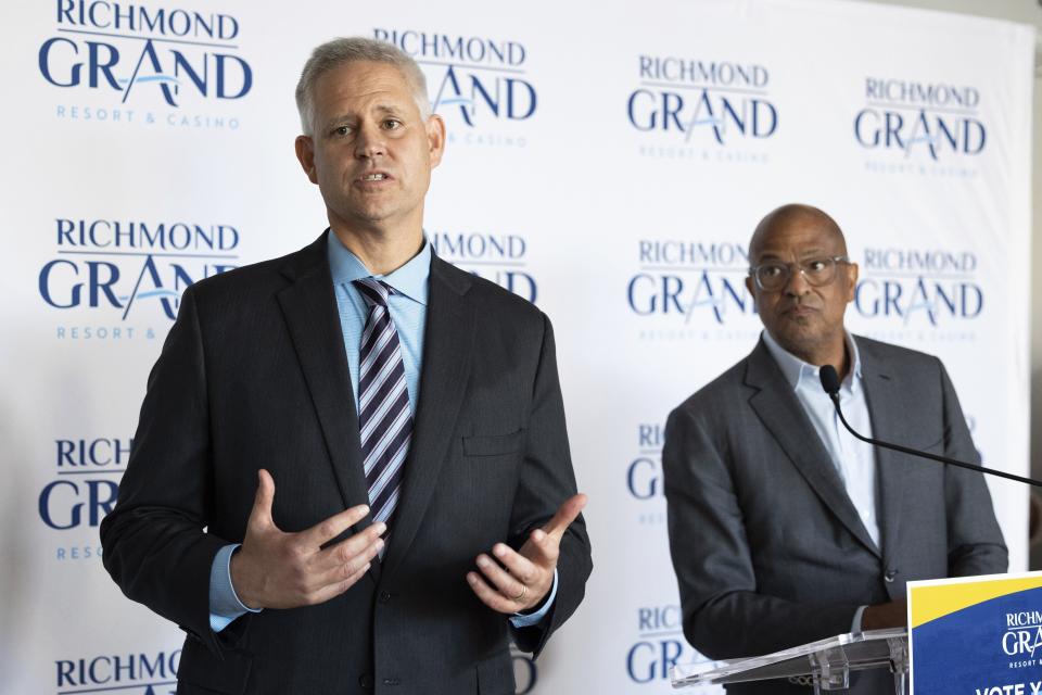 FILE - William Carstanjen, CEO of Churchill Downs, Inc., right, speaks about a resort, casino, and entertainment complex during a news conference as Alfred Liggins, III, CEO of Urban One, Inc., listens, Aug. 31, 2023, in Richmond, Va. Voters in Virginia's capital city will decide on Tuesday, Nov. 7, whether developers can move forward with a proposed $562 million resort casino along Interstate 95. (Mike Kropf/Richmond Times-Dispatch via AP, File)