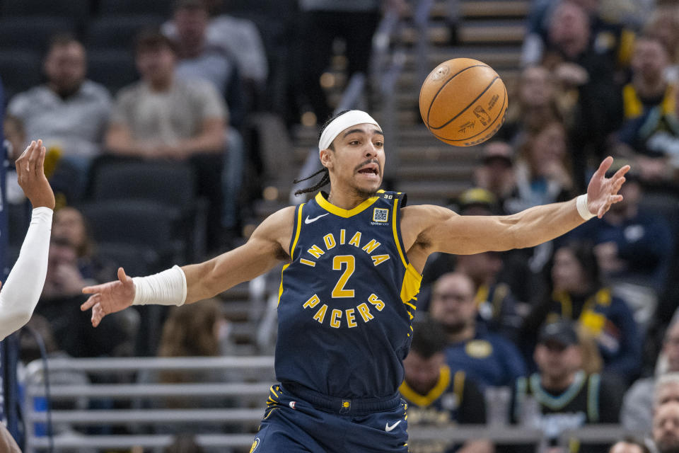 Indiana Pacers guard Andrew Nembhard reaches for the ball after losing control of it during the second half of the team's NBA basketball game against the Detroit Pistons in Indianapolis, Thursday, Feb. 22, 2024. (AP Photo/Doug McSchooler)