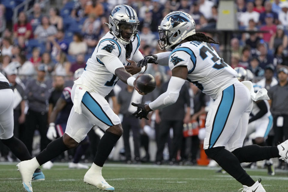 Carolina Panthers quarterback PJ Walker (11) hands off to running back D'Onta Foreman (33) during the first half of the team's preseason NFL football game against the New England Patriots on Friday, Aug. 19, 2022, in Foxborough, Mass. (AP Photo/Michael Dwyer)