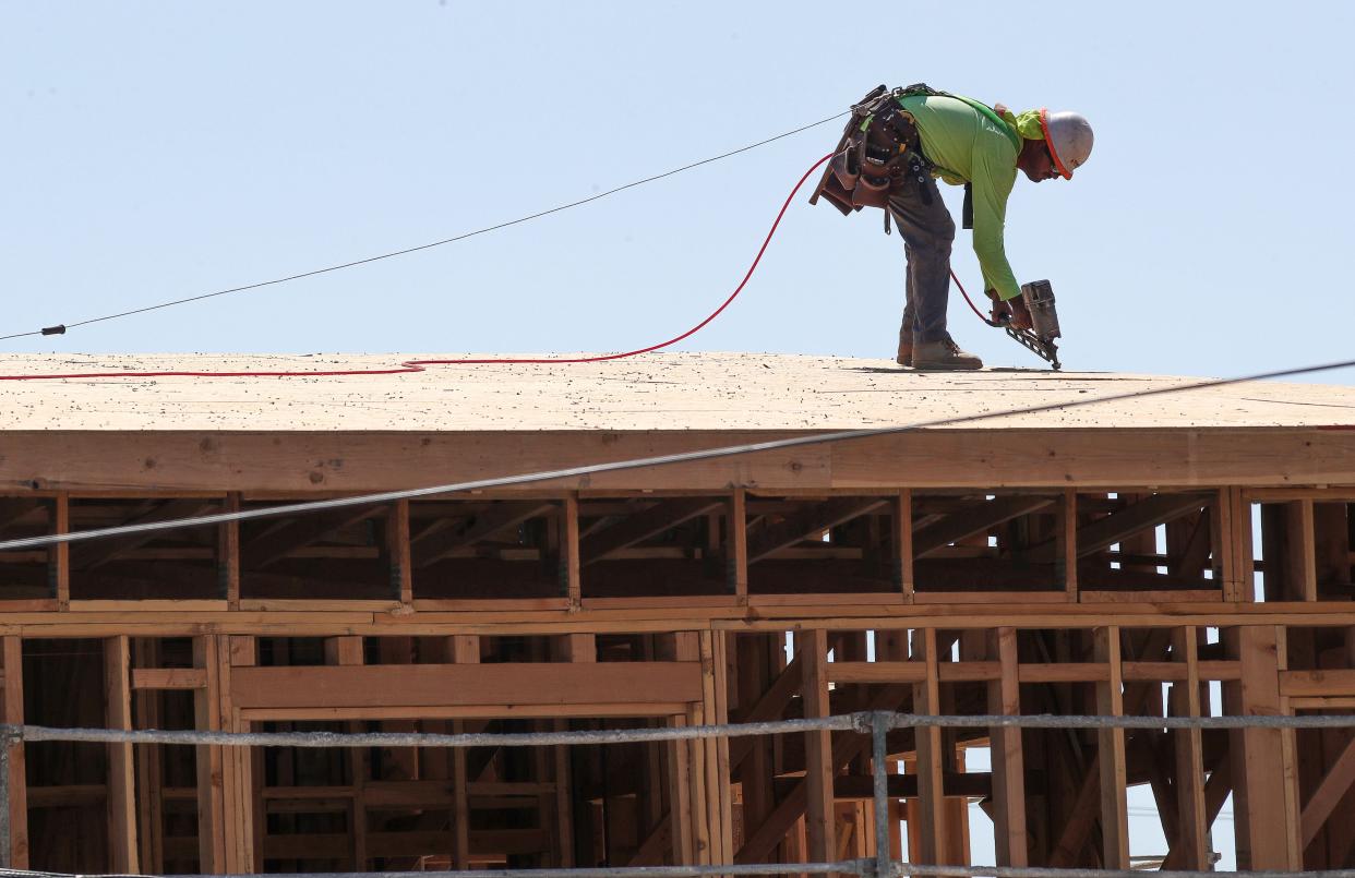 A construction worker on the rooftop of the Monarch Apartment Homes during triple-digit temperatures Monday in Palm Springs. The homes are being built at the southeast intersection of Indian Canyon and San Rafael drives.