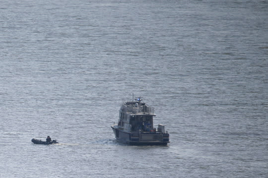 <p>NYPD divers ride a boat on the Hudson River near the site of small plane crash, Saturday, May 28, 2016, in North Bergen, N.J. A World War II vintage P-47 Thunderbolt aircraft crashed into the river Friday, May 27, killing its pilot. (AP Photo/Julio Cortez) </p>