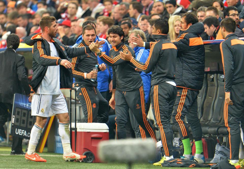 Real's Sergio Ramos shakes hands with teammates as he leaves the game during the Champions League semifinal second leg soccer match between Bayern Munich and Real Madrid at the Allianz Arena in Munich, southern Germany, Tuesday, April 29, 2014. (AP Photo/Kerstin Joensson)