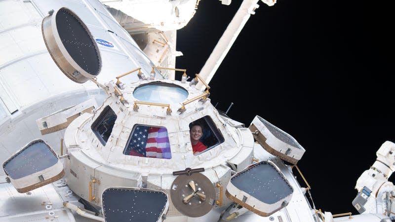 NASA astronaut Nicole Mann looking through the window of the ISS.