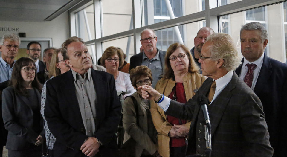 Attorney for clergy abuse survivors, Jeff Anderson, stands in front of survivors after a U.S. Bankruptcy Court approved a settlement that includes $210 million for victims of clergy sex abuse, Tuesday, Sept. 25, 2018, in Minneapolis. U.S. Bankruptcy Court Judge Robert Kressel has approved a reorganization plan for the Archdiocese of St. Paul and Minneapolis that will compensate victims of clergy sex abuse. Hundreds of victims voted overwhelmingly in favor of the plan. (Shari L. Gross/Star Tribune via AP)