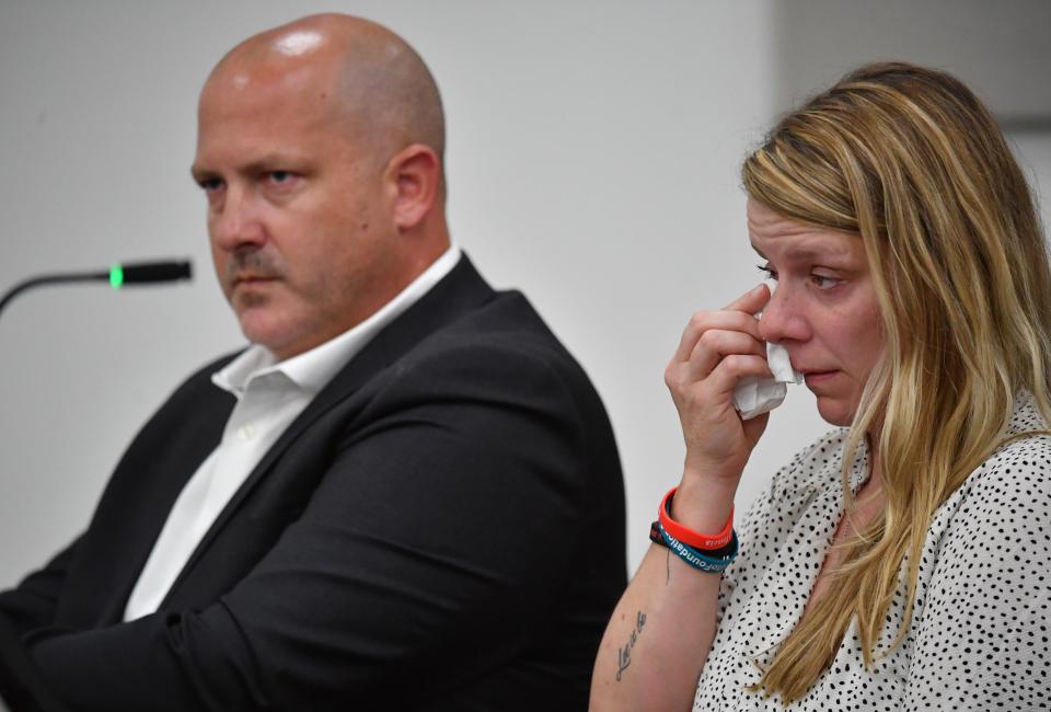 Gabby Petito's parents, Joseph Petito, left, and Nichole Schmidt, right, listen to arguments by an attorney for Brian Laundrie's parents as he seeks to have a negligence lawsuit dismissed in court in Sarasota County, Florida on Wednesday, June 22, 2022.  Petito and Schmidt claim in their lawsuit that the Laundrie's acted maliciously by not telling them where their daughter was and if she was alive..