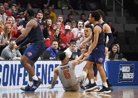 Mar 24, 2019; San Jose, CA, USA; Liberty Flames forward Myo Baxter-Bell (0) reacts after drawing a charge against Virginia Tech Hokies guard Justin Robinson (5) during the first half in the second round of the 2019 NCAA Tournament at SAP Center. Mandatory Credit: Kelley L Cox-USA TODAY Sports
