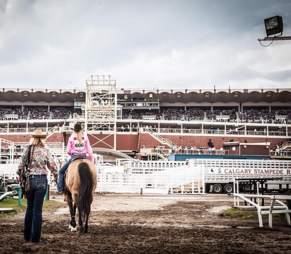 Angela Ganter escorts her daughter, Jackie, to the arena for morning practice at the famous Calgary Stampede rodeo in Calgary, Alberta, in 2016.