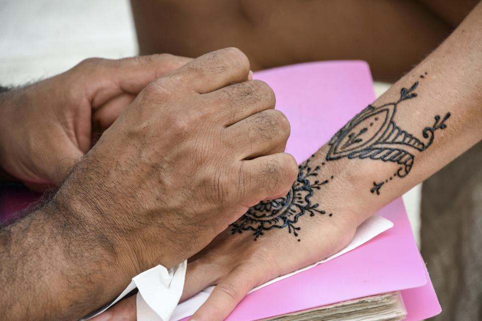 Someone being given a henna tattoo