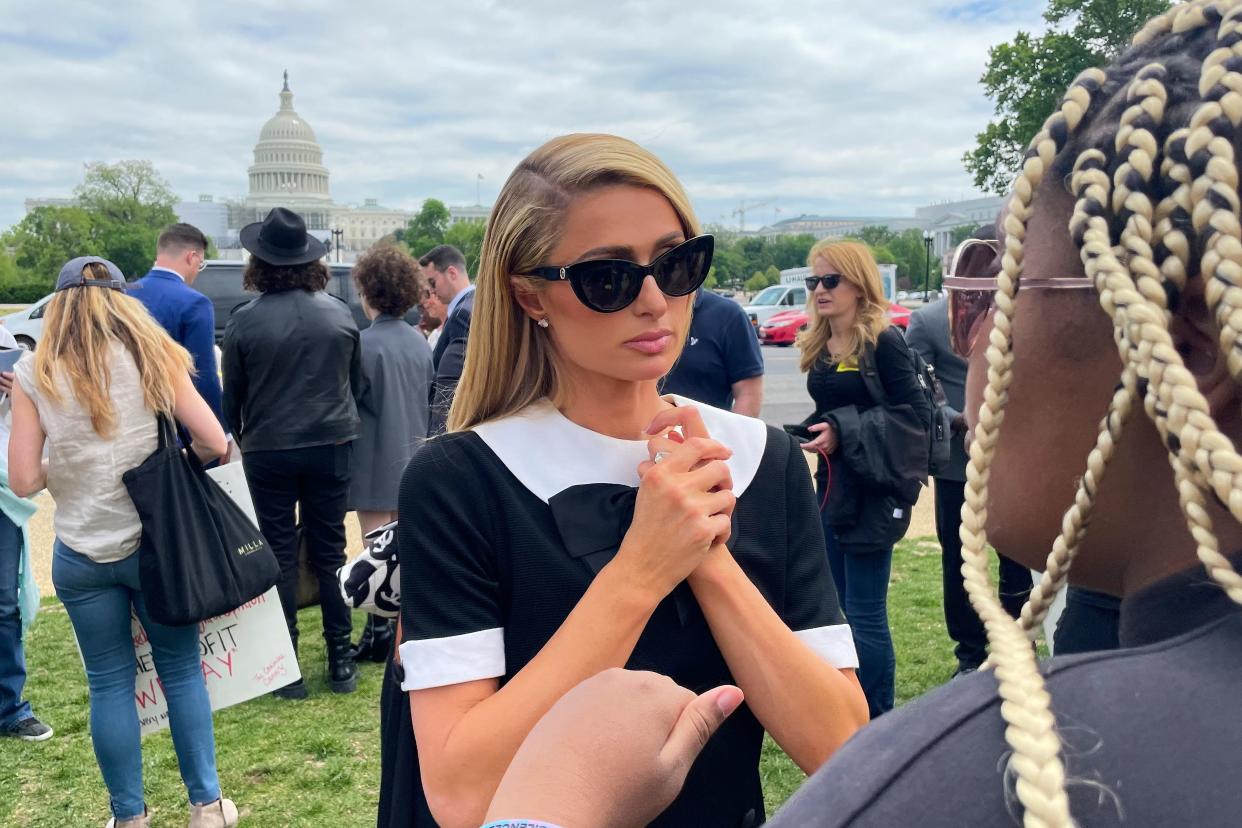 Paris Hilton joins a fellow speaker after the Stop Institutional Child Abuse event on May 11, 2022 in Washington.