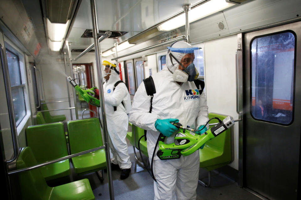 Workers carry out the disinfection of a metro car, as part of Mexico City's government's measures in response to the coronavirus disease (COVID-19), in Mexico City