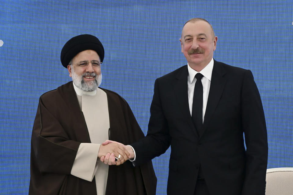 In this photo provided by the Azerbaijan's Presidential Press Office, Iranian President Ebrahim Raisi, left, shakes hands with his Azeri counterpart Ilham Aliyev during their meeting in the inauguration ceremony of dam of Qiz Qalasi, or Castel of Girl in Azeri, at the border of Iran and Azerbaijan, Sunday, May 19, 2024. A helicopter carrying Iranian President Ebrahim Raisi suffered a "hard landing" on Sunday, Iranian state media reported, without immediately elaborating. (Azerbaijani Presidential Press Office via AP)