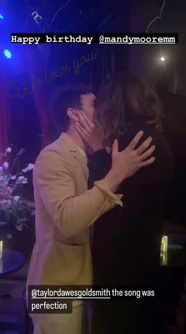 <p>Hilary Duff/Instagram</p> Taylor Goldsmith and Mandy Moore kiss at her birthday celebration