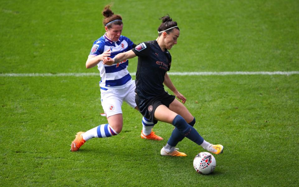 Lucy Bronze of Manchester City is challenged by Emma Mitchell of Reading during the Barclays FA Women's Super League match between Reading Women and Manchester City Women at Madejski Stadium on October 18, 2020 in Reading, England. Sporting stadiums around the UK remain under strict restrictions due to the Coronavirus Pandemic as Government social distancing laws prohibit fans inside venues resulting in games being played behind closed door - Getty Images Europe /Warren Little 