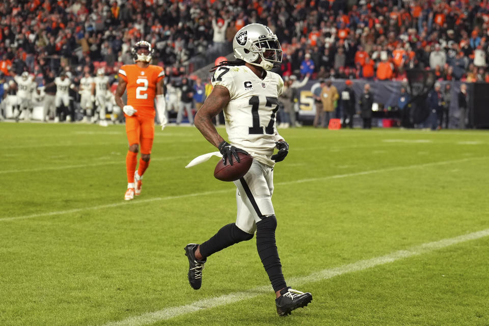 Las Vegas Raiders wide receiver Davante Adams (17) scores the winning touchdown in front of Denver Broncos cornerback Pat Surtain II (2) during overtime of an NFL football game in Denver, Sunday, Nov. 20, 2022. (AP Photo/Jack Dempsey)