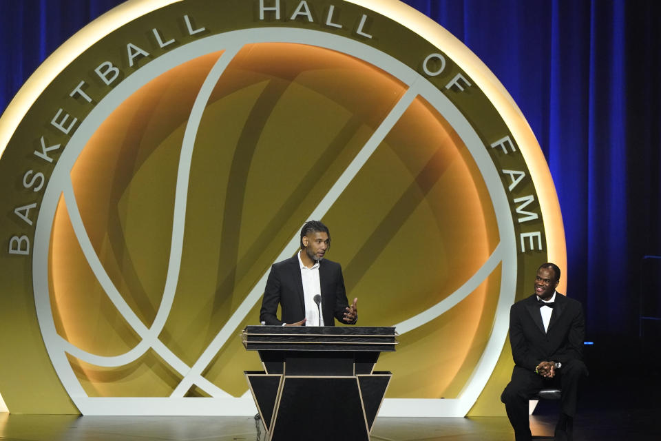 Tim Duncan speaks as presenter David Robinson, right, listens, as Duncan is enshrined with th 2020 Basketball Hall of Fame class Saturday, May 15, 2021, in Uncasville, Conn. (AP Photo/Kathy Willens)