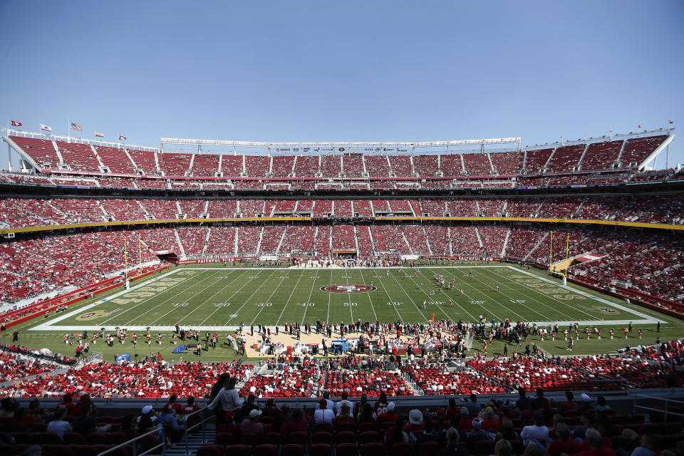 FILE - In this Oct. 7, 2018, file photo, fans watch an NFL football game between the San Francisco 49ers and the Arizona Cardinals at Levi's Stadium in Santa Clara, Calif. With the College Football Playoff title game located thousands of miles away from the two campuses in Alabama and South Carolina, possible fatigue for fan bases of teams that have become annual participants in the playoff and a game site in an expensive market lacking college football die-hards, prices for tickets for Monday night's championship game in Santa Clara have been plummeting the past few days. (AP Photo/Tony Avelar)