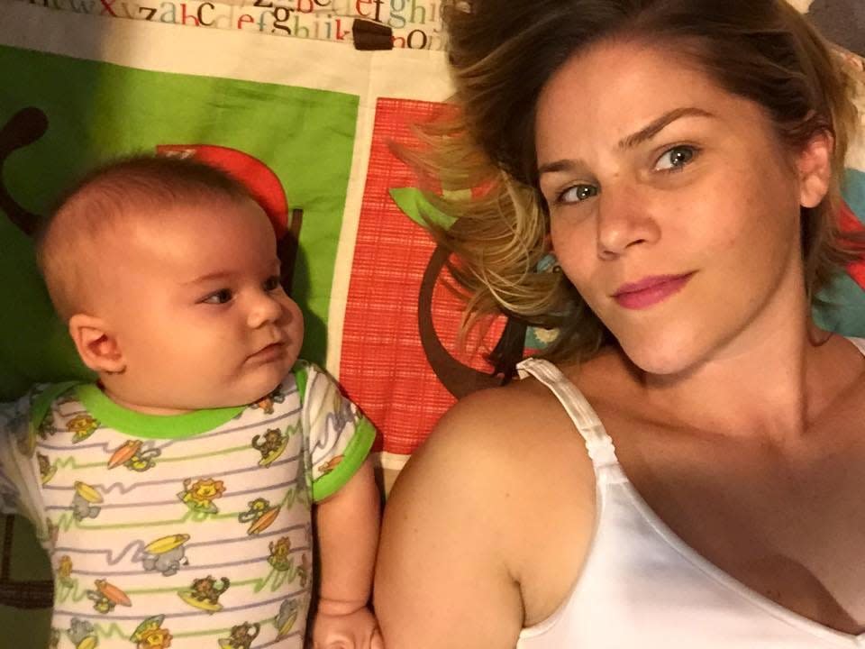Woman laying with her son on the bed