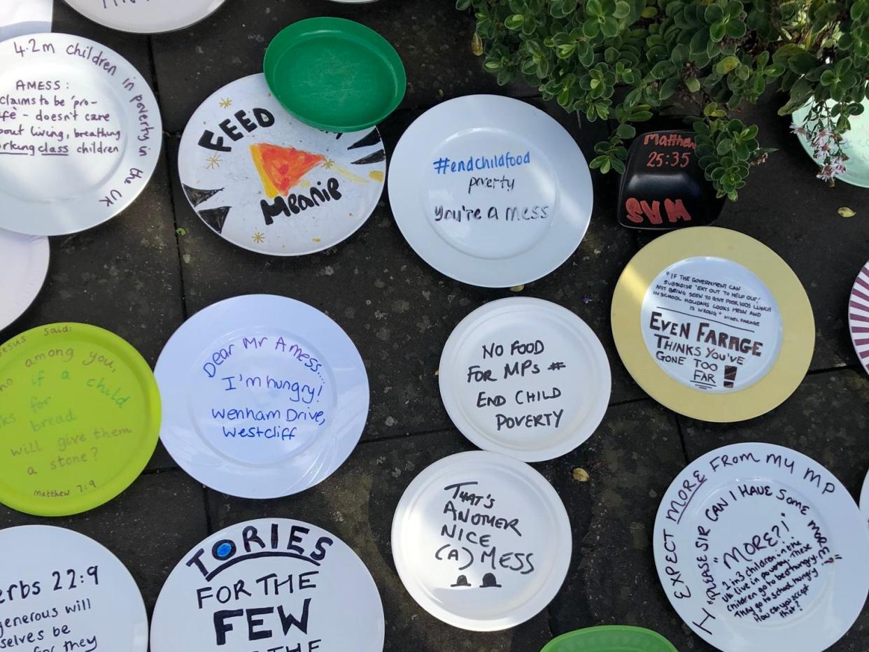 Handout photo issued by Sadie Hasler of empty plates outside a Conservative MP Sir David Amess Southend offices in protest over the party voting against plans to extend free school meals over holidays (PA)