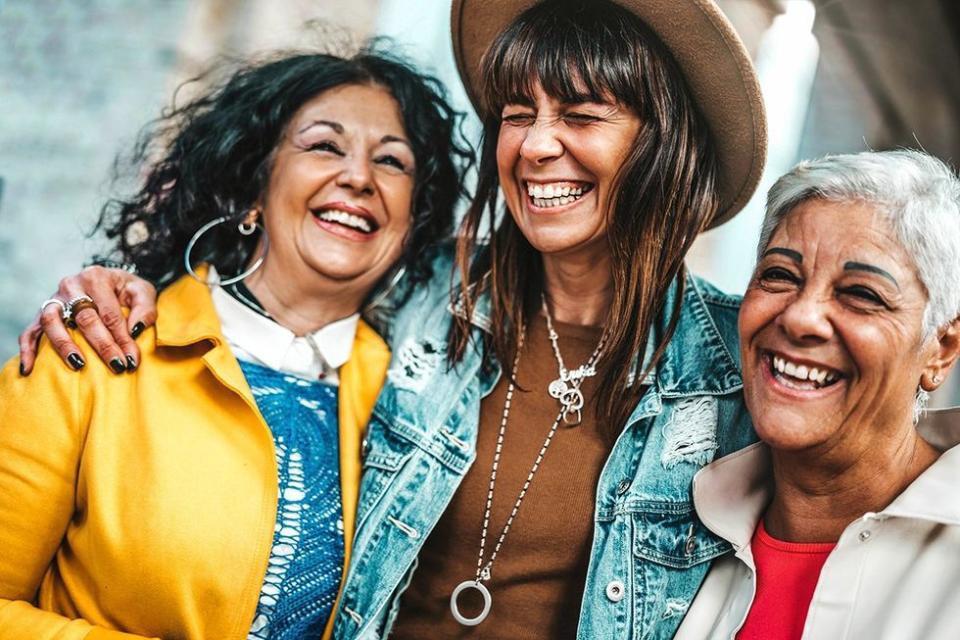 Loneliness epidemic threatens LGBTQ+ community; three generations of Latina women celebrating connection