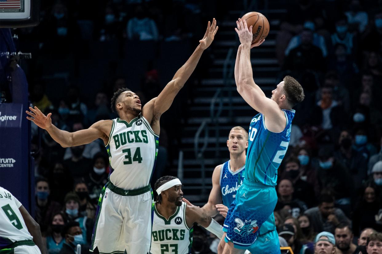 Bucks forward Giannis Antetokounmpo tries  to block the shot of Hornets forward Gordon Hayward on Saturday night in Charlotte.