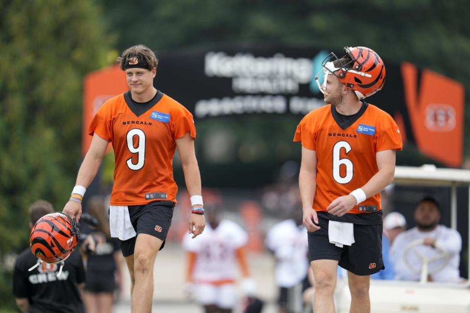 Bengals quarterbacks Joe Burrow (9) and Jake Browning talks during camp.