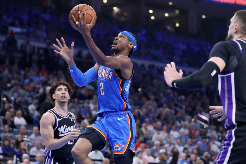 Oklahoma City Thunder guard Shai Gilgeous-Alexander (2) putting s up a shot beside Sacramento Kings guard Colby Jones (20) during an NBA basketball game between the Oklahoma City Thunder and the Sacramento Kings at Paycom Center in Oklahoma City, Tuesday, April 9, 2024. Oklahoma City won 112-105.