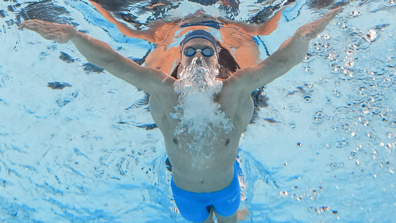 Leon Marchand of France competes in a heat of the men's 200-meter butterfly during the 2024 Summer Olympics, Tuesday, July 30, 2024, in Nanterre, France. (AP Photo/David J. Phillip)