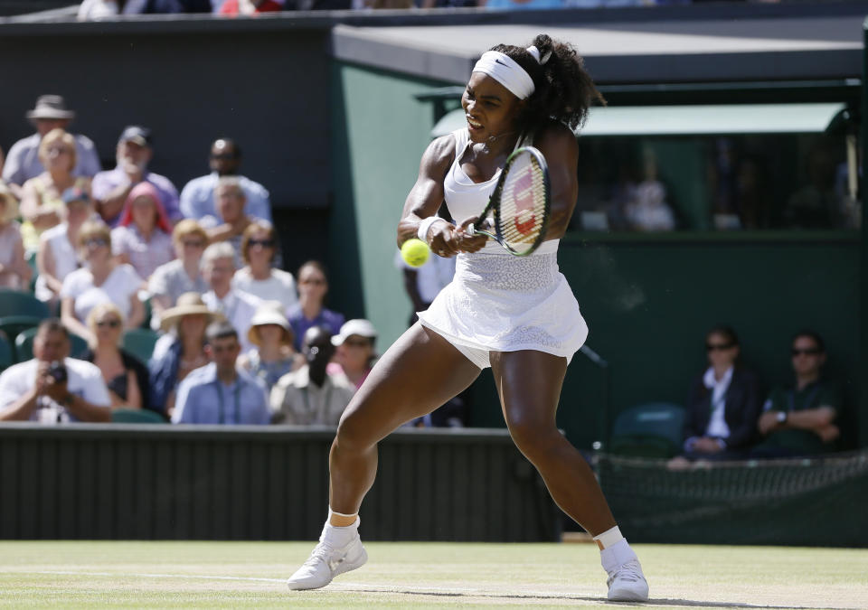Serena Williams of the United States returns a shot to Garbine Muguruza of Spain, during the women's singles final at the All England Lawn Tennis Championships in Wimbledon, London, Saturday July 11, 2015. (AP Photo/Kirsty Wigglesworth)