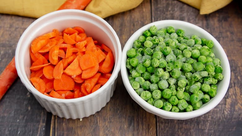 Frozen peas and carrots in separate bowls