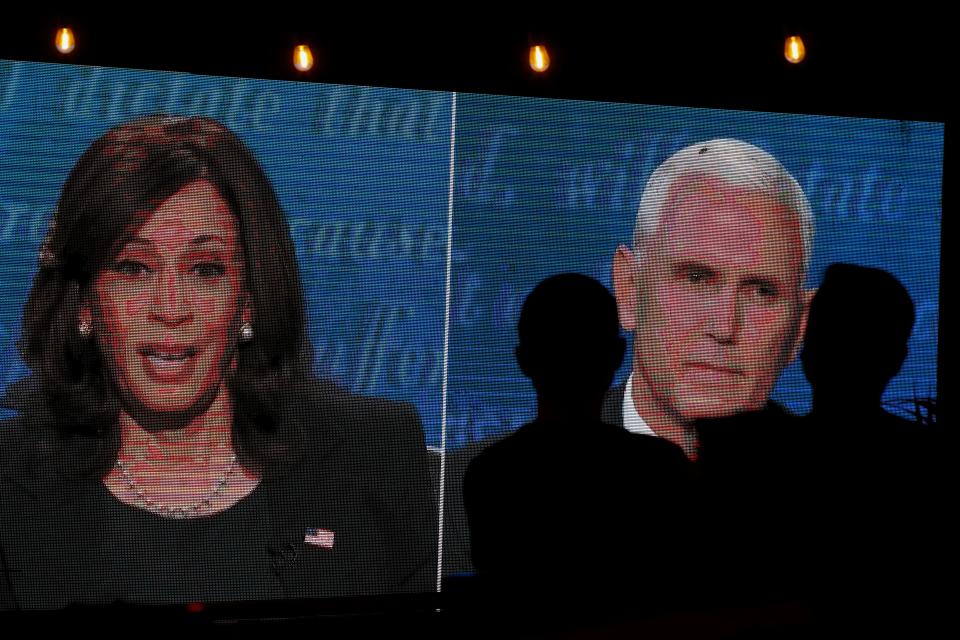 People watch the debate between U.S. Vice President Mike Pence and Democratic vice-presidential nominee Kamala Harris outside a tavern in San Diego, California, U.S., October 7, 2020.