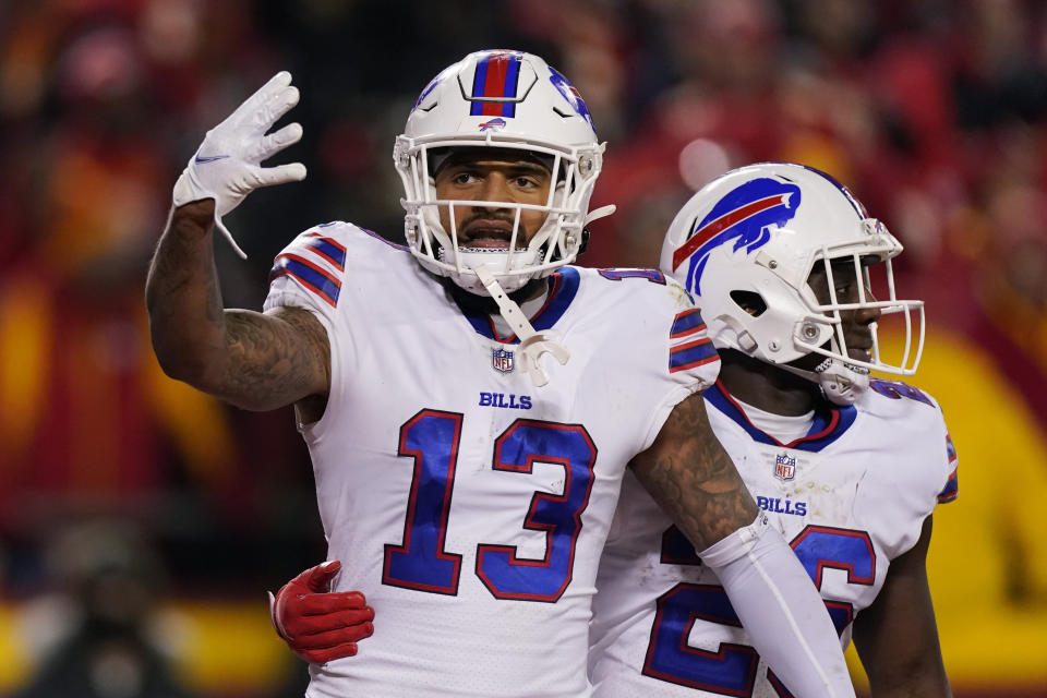 Buffalo Bills wide receiver Gabriel Davis (13) celebrates with teammate Devin Singletary (26) after catching a 19-yard touchdown pass during the second half of an NFL divisional round playoff football game against the Kansas City Chiefs, Sunday, Jan. 23, 2022, in Kansas City, Mo. (AP Photo/Charlie Riedel)