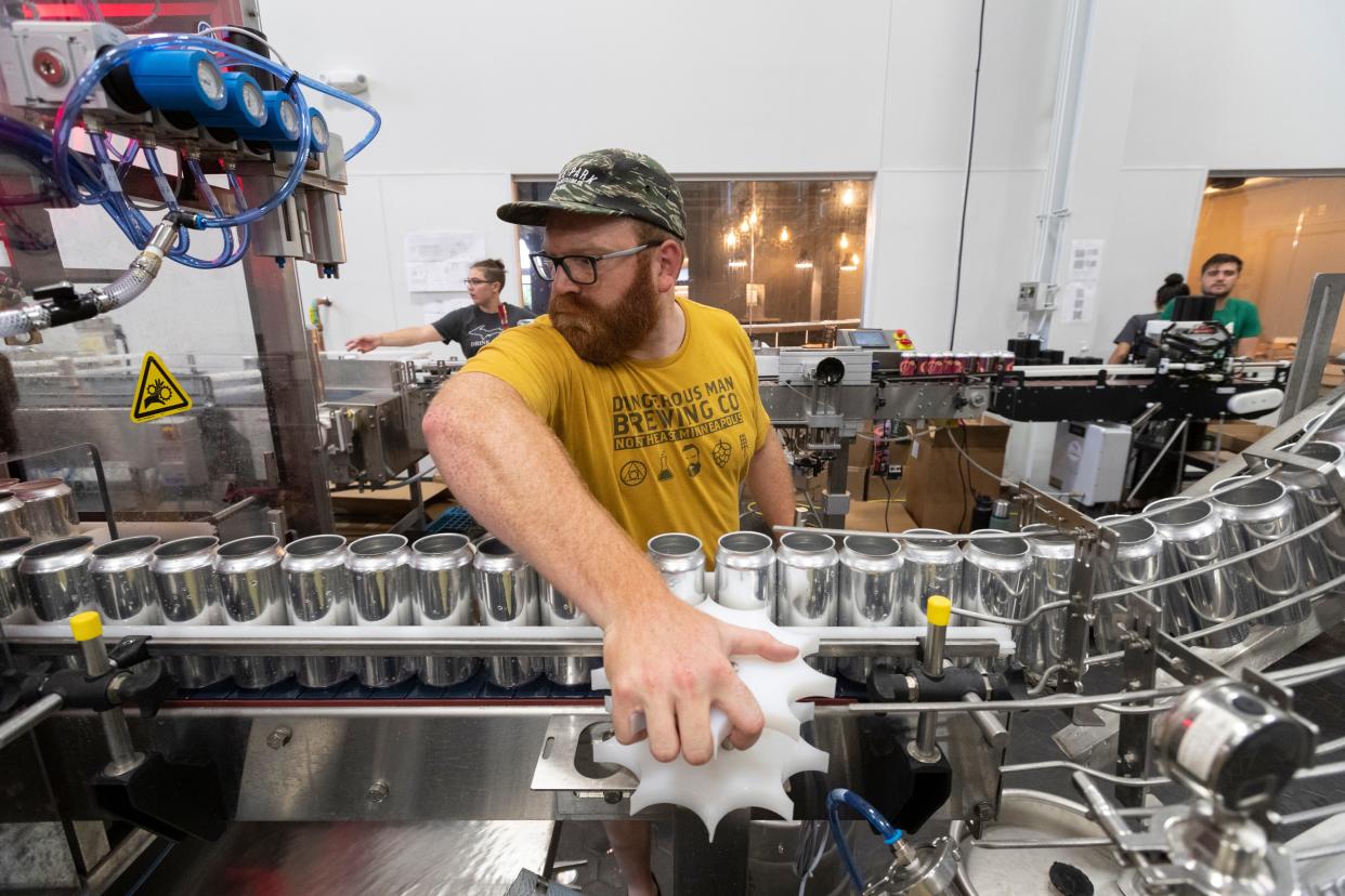 Co-owner Jake Schinker works on the canning line in 2020 at Eagle Park Brewing Co. in Muskego.