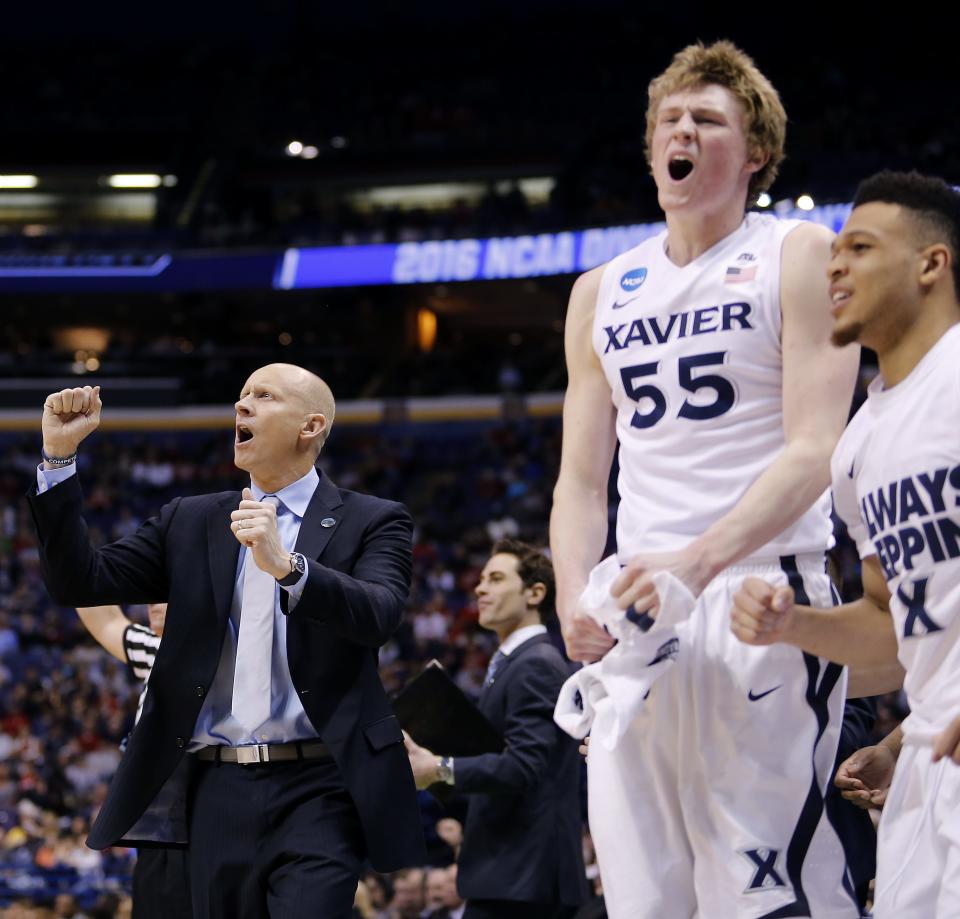 Xavier's head coach Chris Mack, left, and J.P. Macura, and Larry Austin, Jr. react after a Musketeer missed a shot in the 2nd half during the second round of the NCAA Tournament at the Scottrade Center in St. Louis Sunday March 20, 2016. Xavier lost 66-63 on a buzzer beater by Wisconsin.