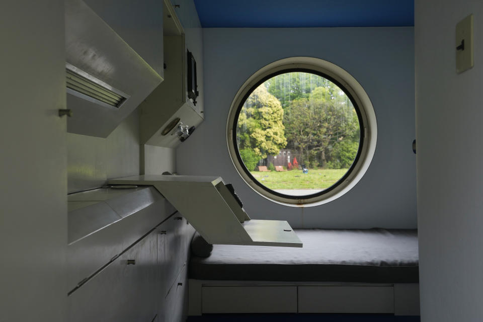 An example of the capsule designed by architect Kisho Kurokawa is displayed in a park outside of the Museum of Modern Art, Saitama, in Saitama, north of Tokyo on May 6, 2022. Kurokawa used capsules to build the Nakagin Capsule Tower, a famed residential and office building in Tokyo's Ginza district. (AP Photo/Hiro Komae)