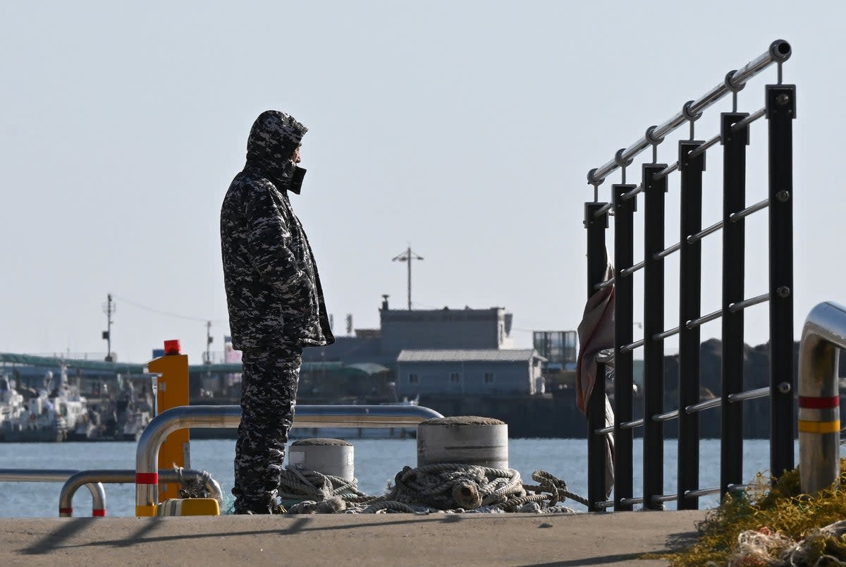 A man stands on a pier at Yeonpyeong island, near the ‘northern limit line’ sea boundary with North Korea, on 6 January 2024, a day after North Korea’s shelling (AFP via Getty Images)