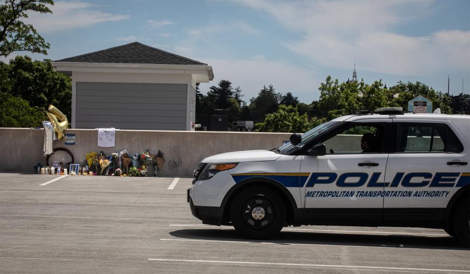 An MTA police officer sits in her car June 11, 2024, near a memorial created on the top floor of a parking garage near the Harrison Metro-North station June 11, 2024. The memorial is for Mark Anthony Giordano, the 13-year-old Harrison resident who died Sunday in an accident involving an electric-powered bike. Giordano fell to the bottom of the five-story garage after apparently losing control of the bike he was riding.