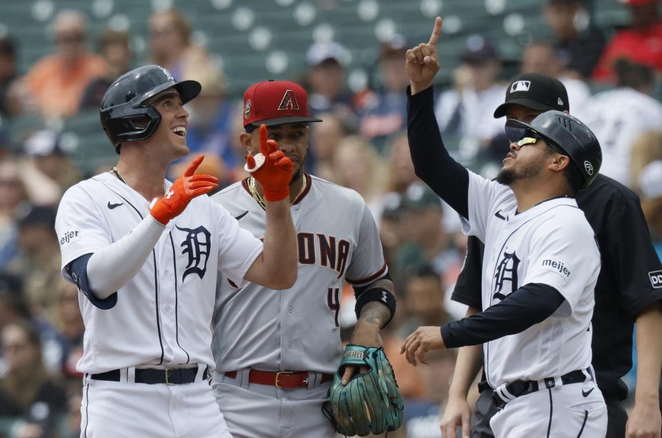 First baseman Ketel Marte of the Arizona Diamondbacks looks on as Kerry Carpenter of the Detroit Tigers and first base coach Alfredo Amezaga celebrate a single during the third inning at Comerica Park on June 11, 2023 in Detroit, Michigan.